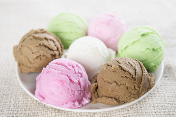 Assorted ice cream scoops on plate.