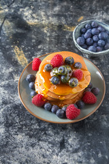 Stack of pancakes with fresh blueberry and maple syrup