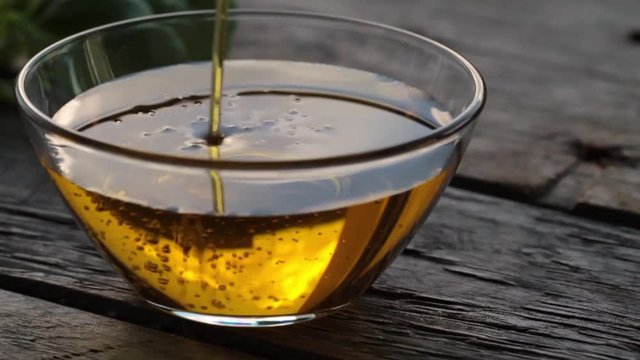 Pouring olive oil into the small bowl. HD Video Stock footage.