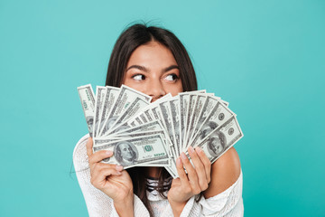 Pretty happy young woman holding money.