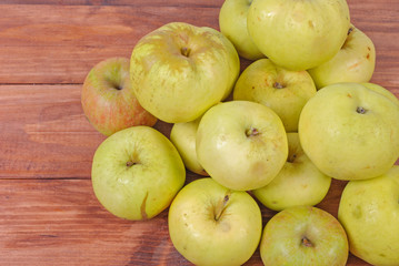 green apples lying on a wooden background