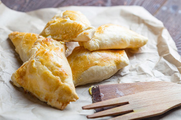 Russian Pies with Egg and Cheese on Dark Wooden Background, Horizontal Close Up View