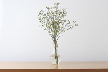 White flowers in vase on the wood table