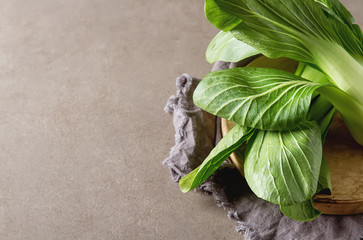 Overhead shot of Chinese cabbage, Bok Choy, on rustic background
