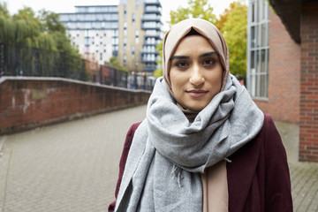 Portrait Of British Muslim Woman In Urban Environment