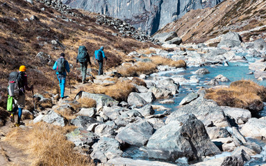 Group of Hikers walking on Footpath in Mountains rear View