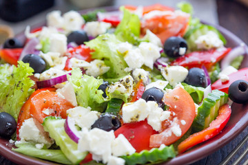 Greek Salad with Fresh Vegetables, Feta Cheese and Black Olives, Close-up View