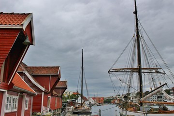 Old wooden boat houses and sailing boats in Haugesund. In the 19th century the town was famous for its herring fishery. On the west coast of Norway, Scandinavia, Europe. 