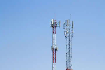 Mobile phone communication tower transmission  signal with blue sky background and antenna and twin