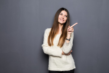 Fototapeta premium Portrait of a pretty girl pointing finger away