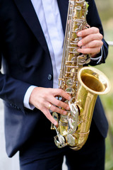 handsome musician is playing saxophone
