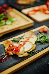 Tasty chicken steak with tomato sauce and aromatic herbs