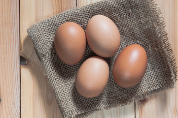 Egg on sack and wooden background,soft focus.