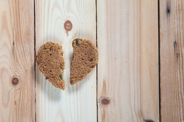 Heart shape cookie and crumb for valentine day on wooden background,soft focus.