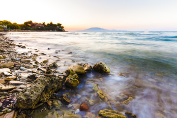 Fototapeta na wymiar sea waves on the stone beach at sunset, Zakynthos, Greece