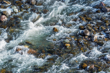 Raging water in threshold of the mountain river