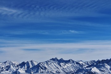 Snowy mountains and blue sky in Austria.