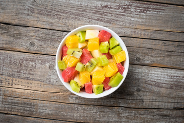 Fresh fruit salad on an old wooden background