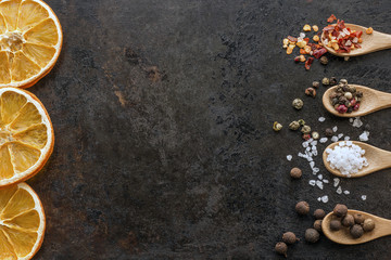 dried orange slices and spices on rusty metal background. Image with copy space.