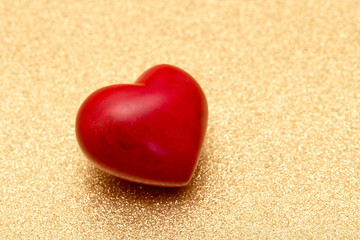 big red heart on golden background