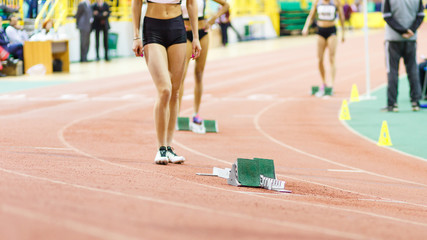 Sportswoman standing near starting blocks before sprint running event