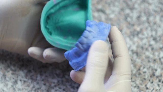 Closeup of a dental technician making of denture in a dental lab