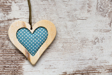 blue colored wooden heart on white wooden wall
