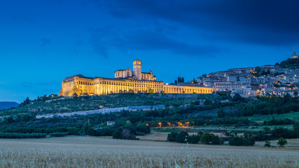 Historic town of Assisi illuminated in twilight, Umbria, Italy