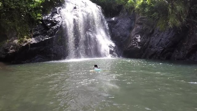 FJ 149 Tourist woman jumps into a Waterfall