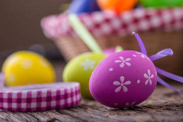 Fototapeta na wymiar Easter. Multicolored easter eggs in a basket on a wooden table.