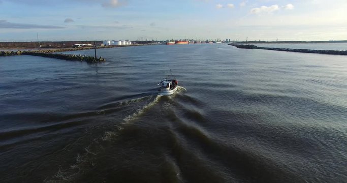 Fishing boat returns to port. Aerial footage - 3