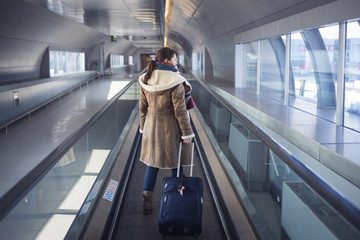 Young woman in airport traveling to a tourist attraction
