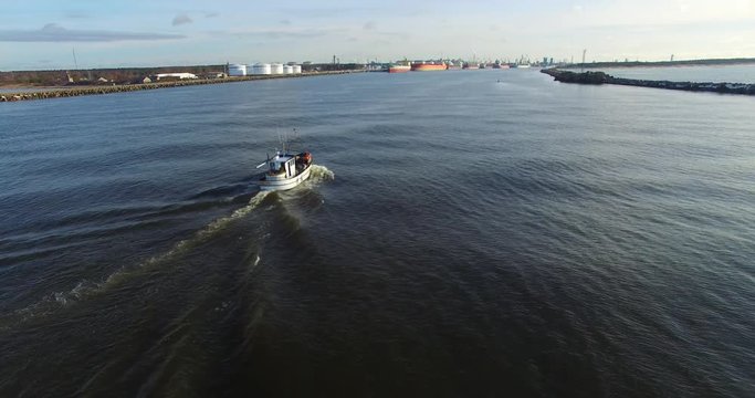 Fishing boat returns to port. Aerial footage - 2