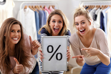 Group of happy friends shopping in store