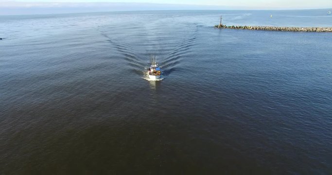 Fishing boat returns to port. Aerial footage - 1