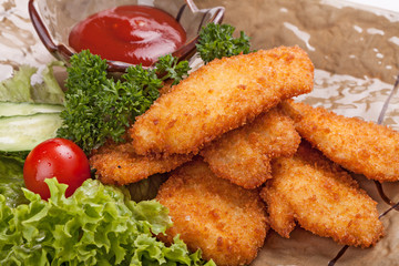 Pieces of chicken fried in batter garnished with vegetables.