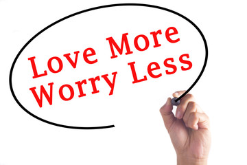 Hand writing Love More Worry Less on transparent board