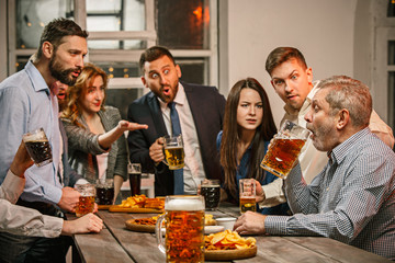Group of friends enjoying evening drinks with beer