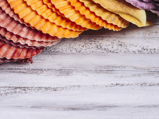 Colorful seashells on a wooden background