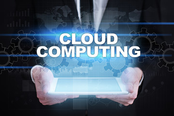 Businessman holding tablet PC with cloud computing concept.