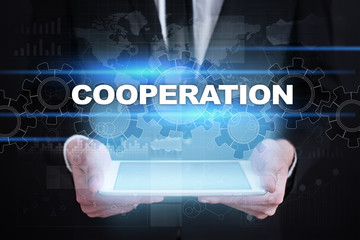 Businessman holding tablet PC with cooperation concept.