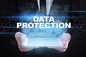 Businessman holding tablet PC with data protection concept.