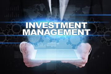 Businessman holding tablet PC with investment management concept.