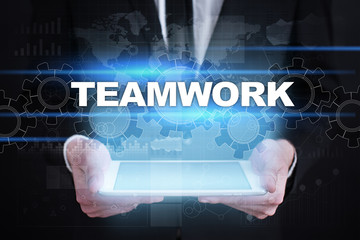 Businessman holding tablet PC with teamwork concept.