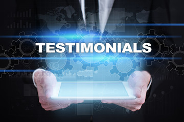 Businessman holding tablet PC with testimonials concept.