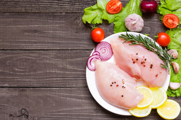 Raw chicken breast fillets on a plate ready for cooking