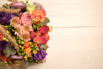Bouquet of flowers in wooden box 
