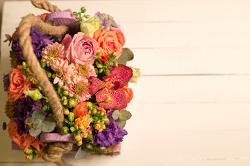 Bouquet of flowers in wooden box 