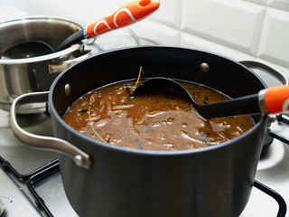 Cooking traditional French onion gratin soup