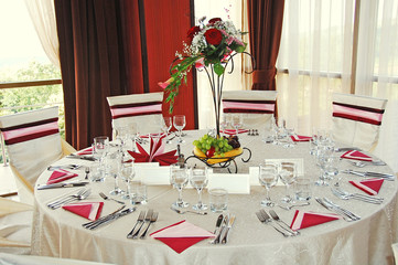Romantic wedding table, indoor restaurant, drink glasses and floral arrangement with fruits
